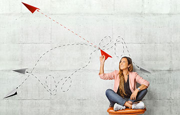 Girl distributing paper airplanes